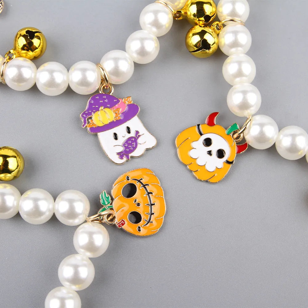 Halloween decorative pet collar with simulated pearls and a choice of pumpkin-themed charms: purple ghost, skull, or smiling.