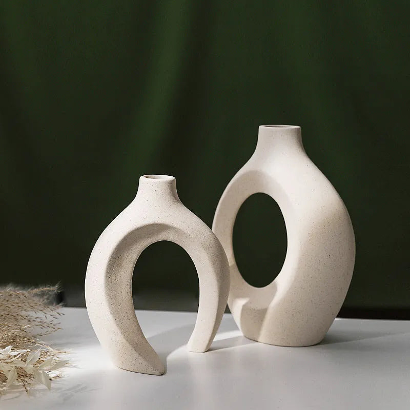 Two European ceramic vases with glazed snuggle colour finish, set on a shelf for creative home decoration