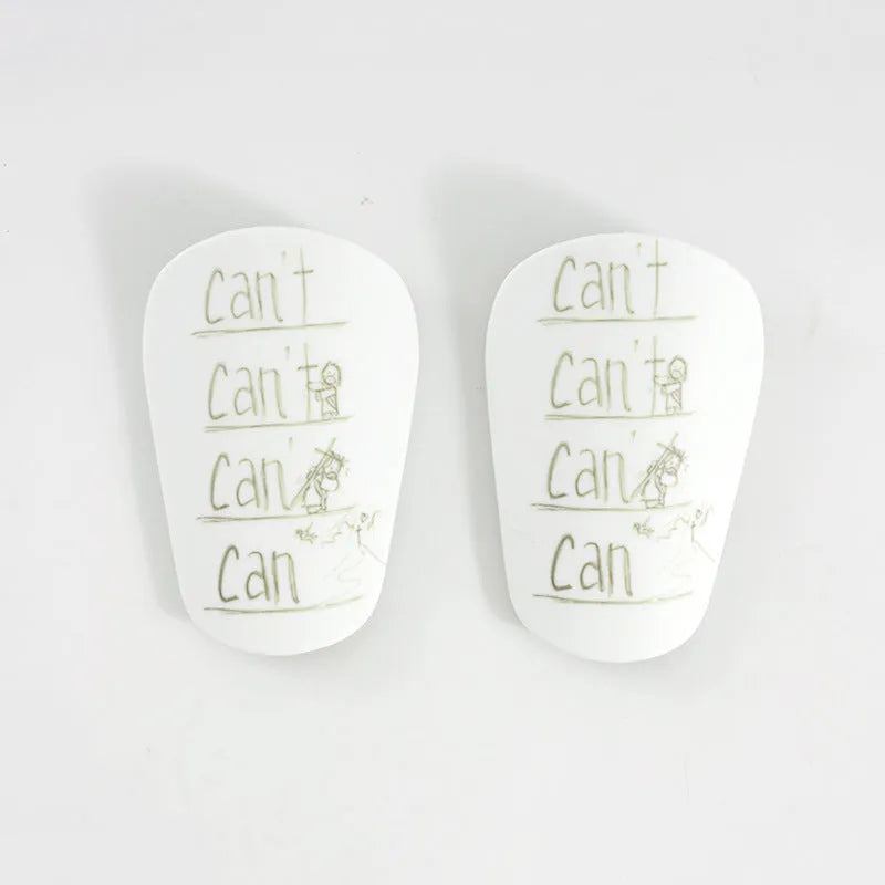 Pair of football shin guards for S and XS size in black, blue, white, or white-black colour.