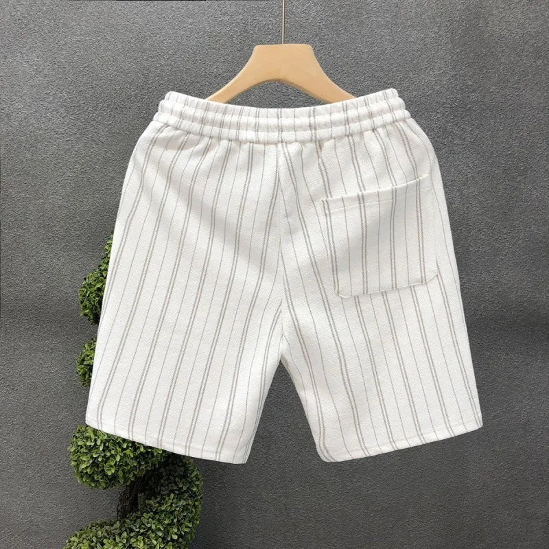 Men's black and white striped fleece-lined casual shorts on a neutral background.