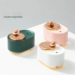 Green rotating planet-shaped USB humidifier with night light on wooden desk