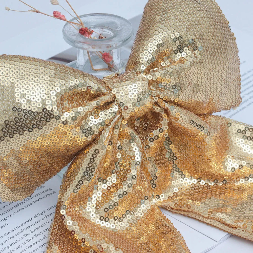 Pearlescent sequined Christmas bow decoration in gold, red, or silver, available in 20X25, 25X30, and 35X40 sizes.