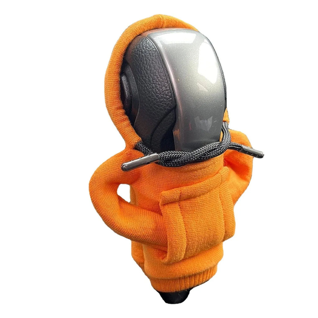 Cloth car gear shift knob hoodie cover in multiple colour options next to a gear lever.