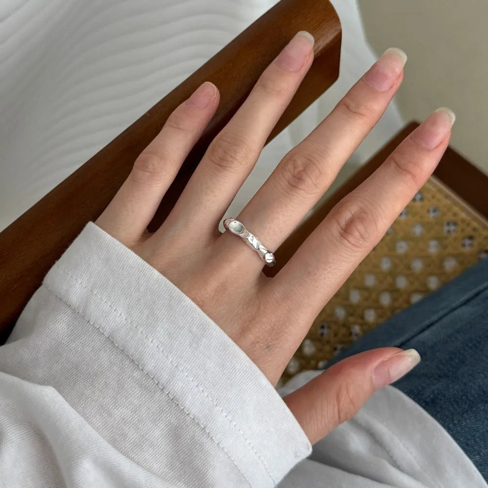 Irregular silver opening adjustable ring for women with electroplated finish on plain background