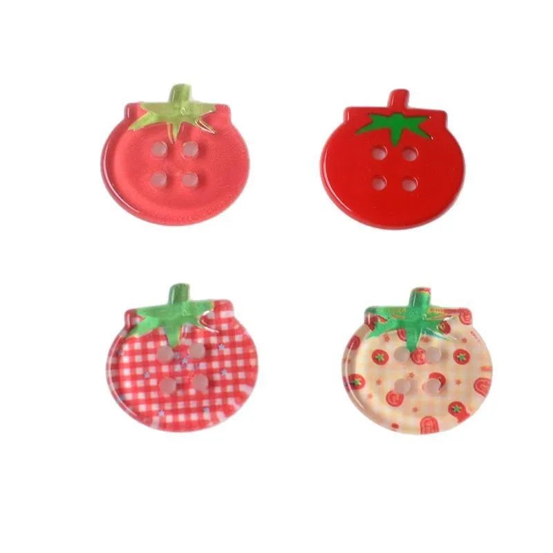 A pack of medium-sized plastic tomato button ornaments in mixed colours including red plaid and cherry tomato print.
