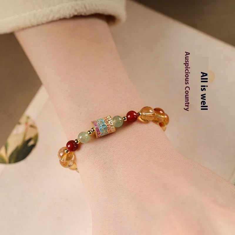 Yellow citrine bracelet with prayer wheel centrepiece and 8mm round beads