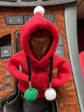 Knitted gear lever hooded sweater with coloured pom poms on car gearstick