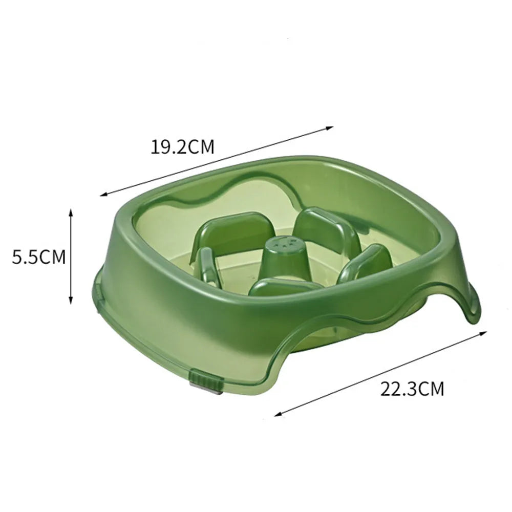 A blue plastic slow-feeder dog bowl on a wooden floor.
