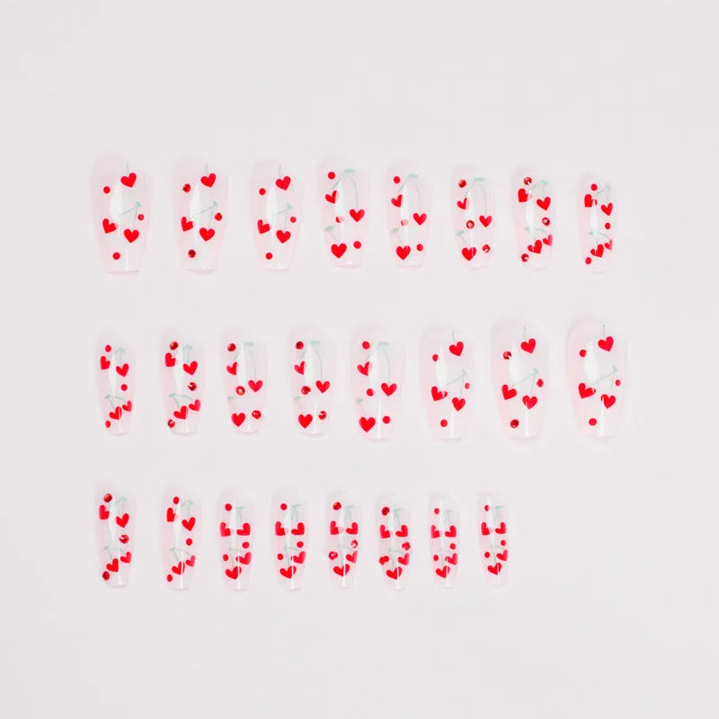 Pack of 24 red French love themed nail art stickers with small cherry and diamond designs, includes glue.