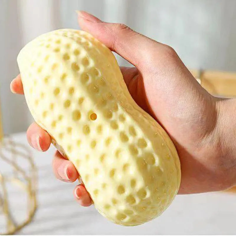 Yellow TPR peanut-shaped dog chew toy with textured surface for teeth cleaning.