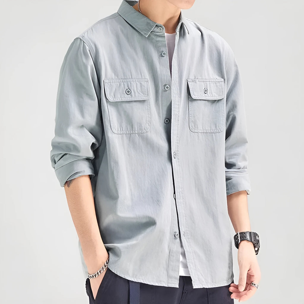 Man wearing a loose grey cardigan-style long sleeve shirt
