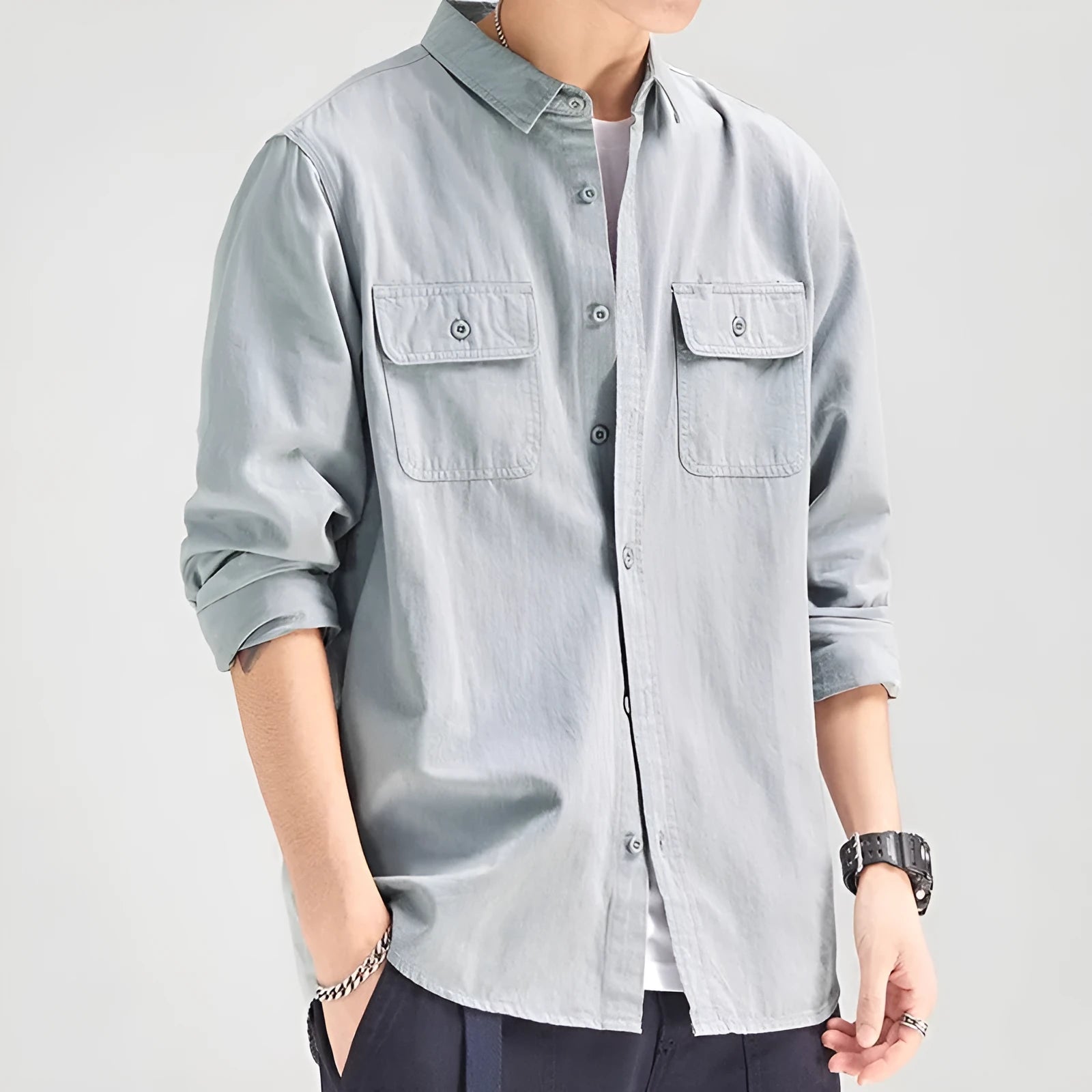 Man wearing a loose grey cardigan-style long sleeve shirt