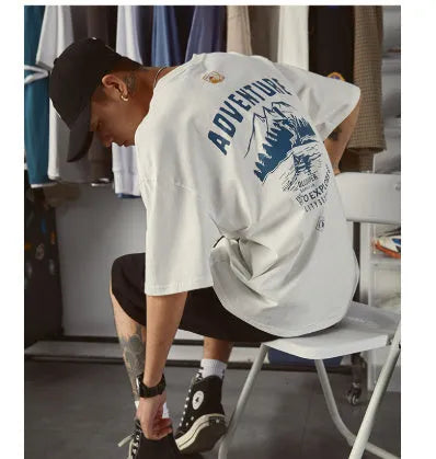 A man wearing a black plus size short-sleeved casual T-shirt.