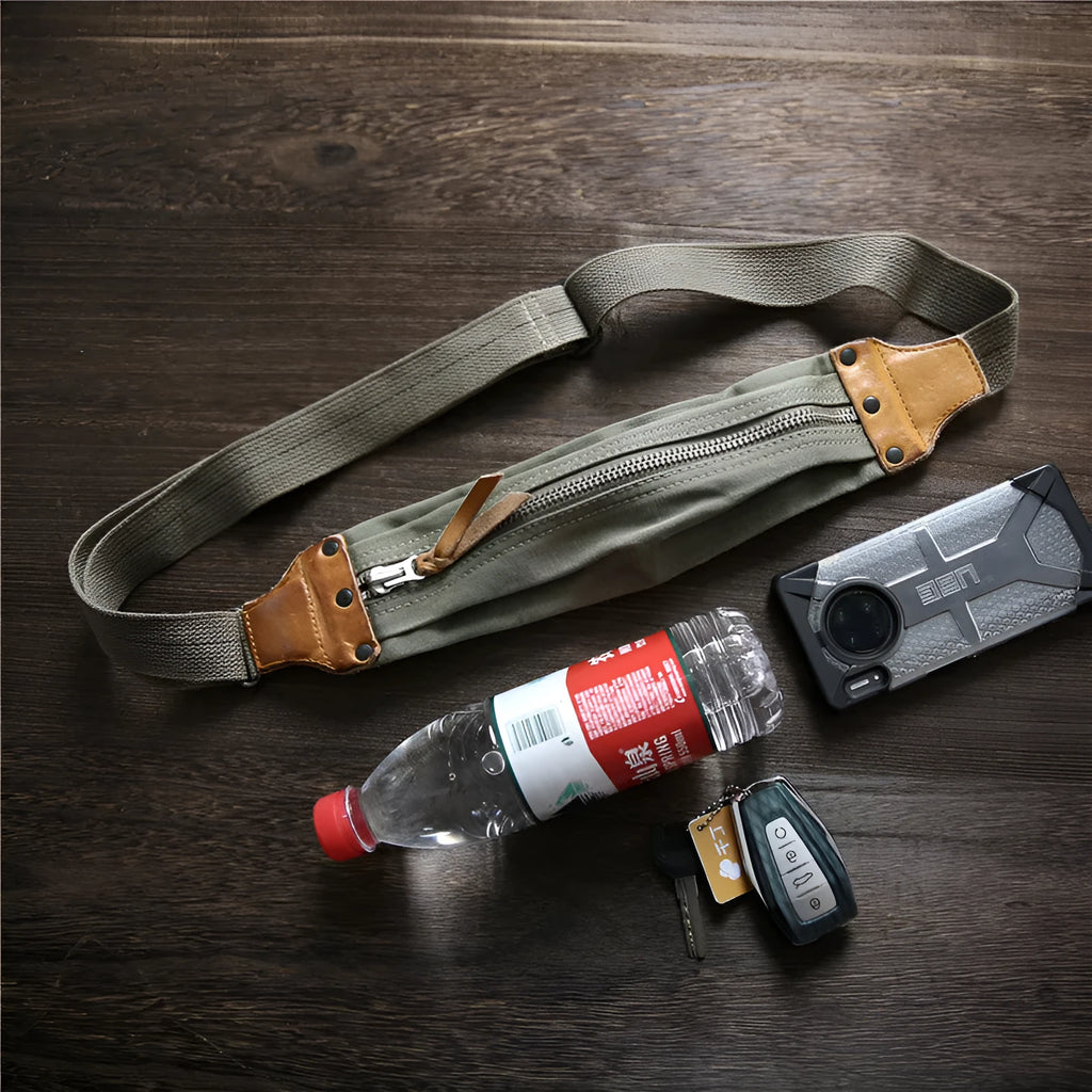 Green military style chest bag with washed canvas exterior and brown Italian leather accents