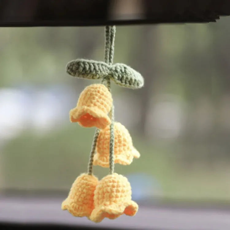 Green and white knitted wool plant ornament for car dashboard with hanging cord