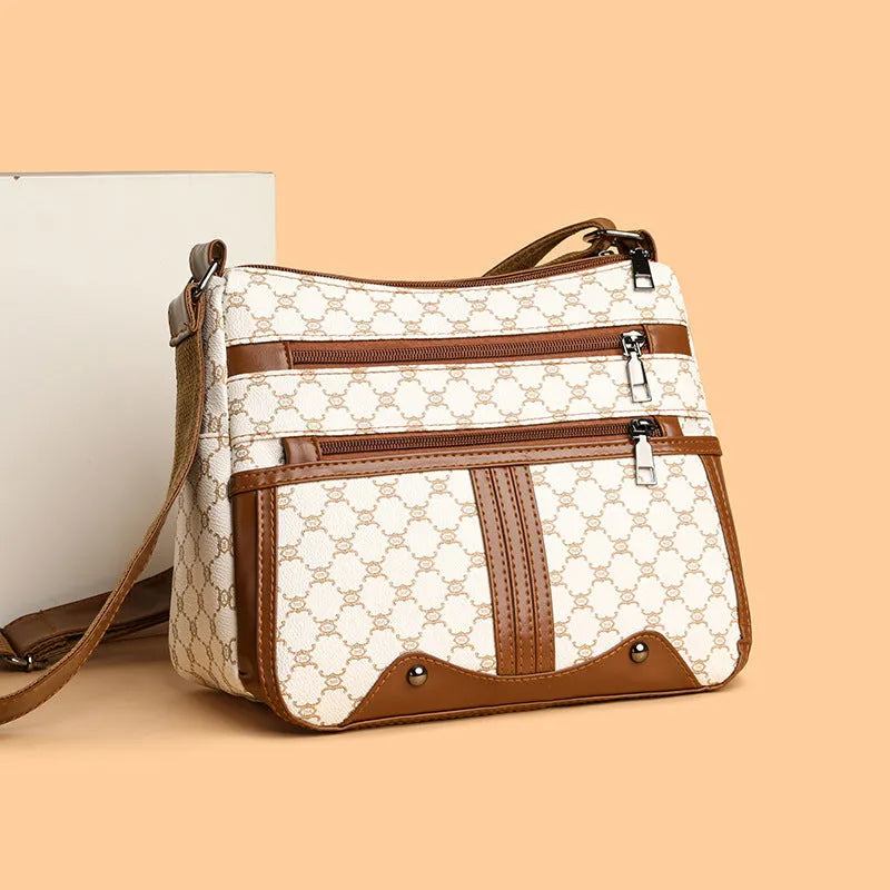 Brown women's crossbody bag with stitching pattern and adjustable shoulder strap.
