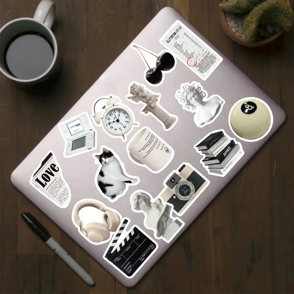 Assortment of 61 black and white line-art PVC stickers for laptops and luggage.