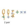 Gold and silver flower-shaped ear studs with blue zircon mosaic decoration.