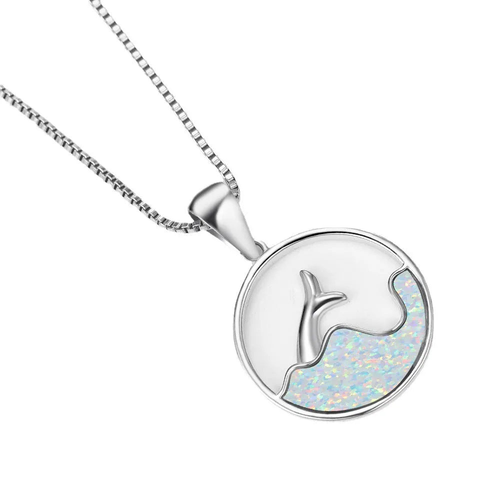 Geometric fishtail pendant necklace with a round blue opal on a silver-toned chain.