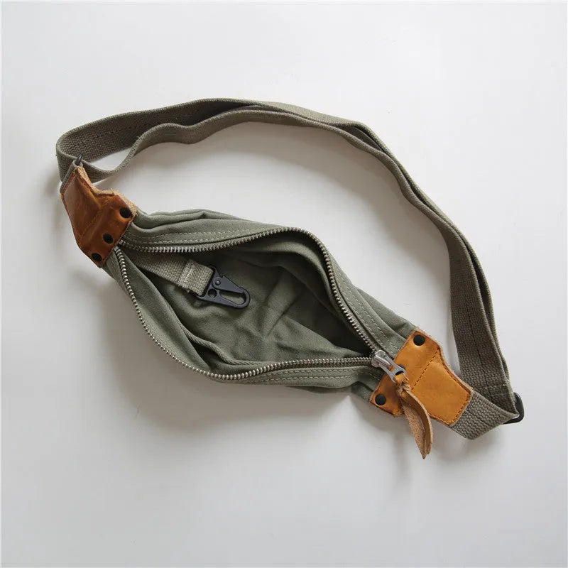 Green military style chest bag with washed canvas exterior and brown Italian leather accents