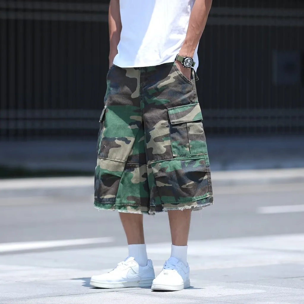 Loose-fit cotton camouflage shorts in retro workwear style on a plain background.