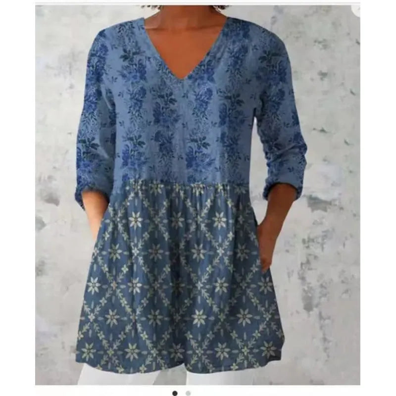 Women's loose-fitting dress with a blue wave print pattern, wide waist, and three-quarter length sleeves.