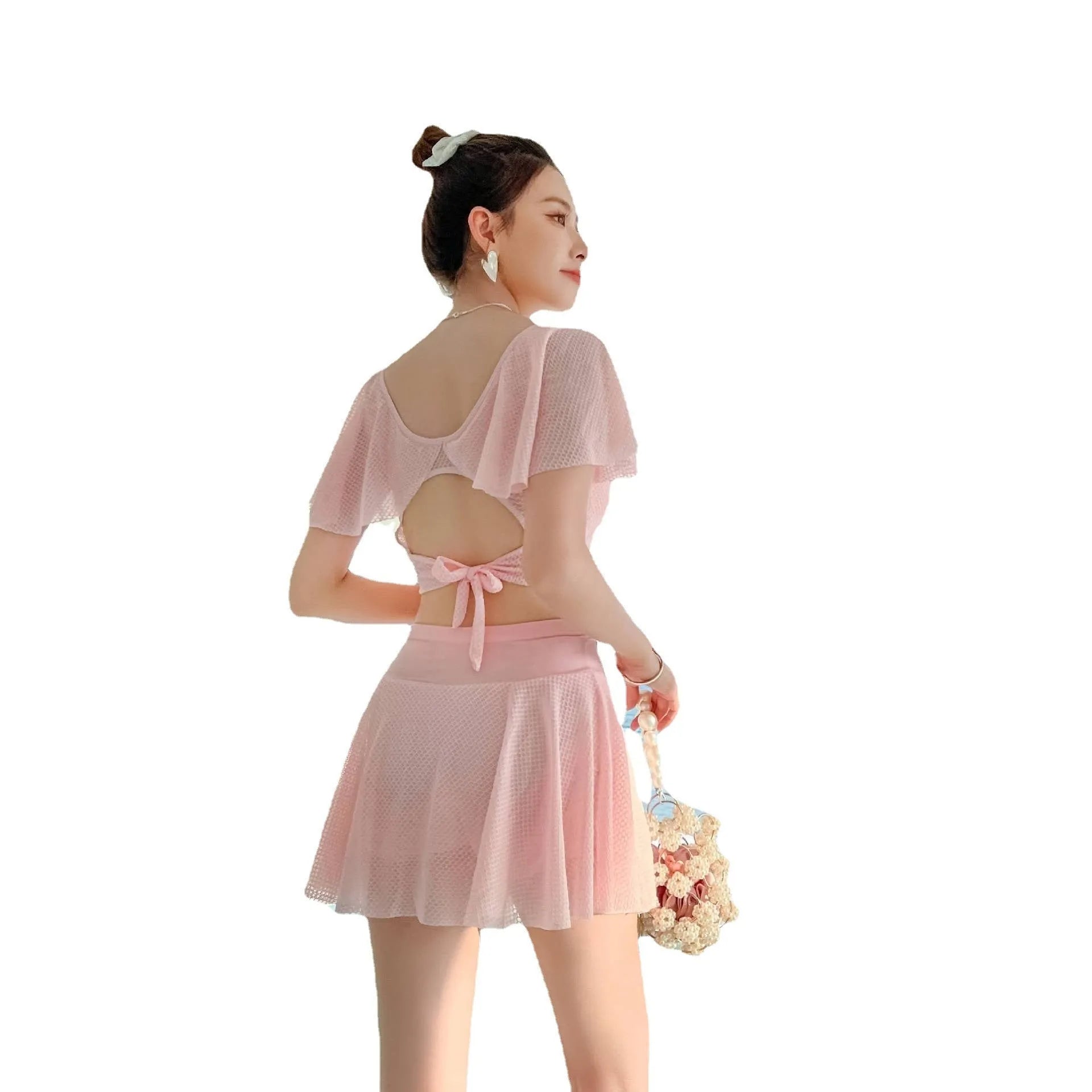Women's solid colour two-piece swimsuit set with a skirt, shown in white, black, or pink.