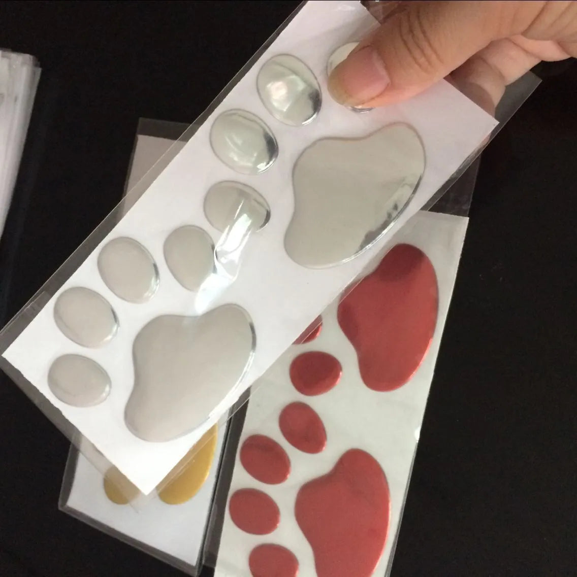 PVC car sticker pair featuring hand-shaped brush dog footprints design in choice of colours