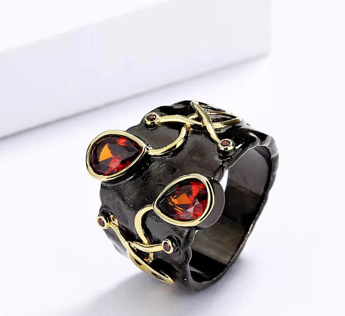 Retro women's straight-pull oval ring in brass with black finish, side view on light background