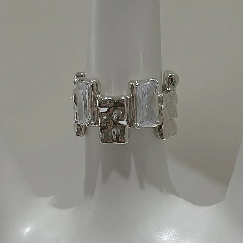 Silver geometric ring with cross zircon detailing and open gemstone setting