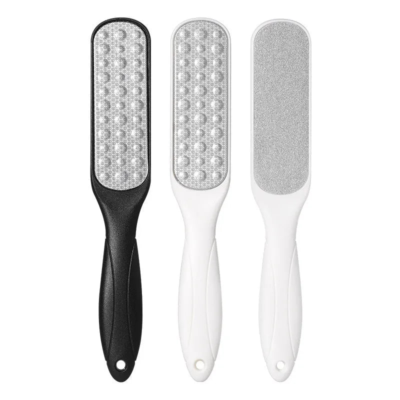 Stainless steel double-sided foot grinder tool with white and black abrasive units for manual foot care.