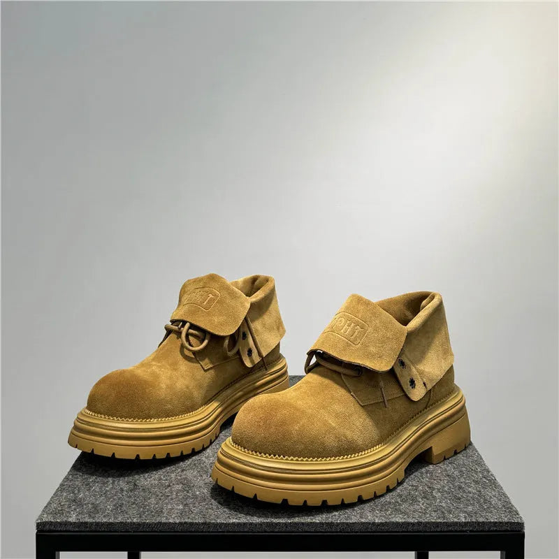 Retro distressed worker boots in cow suede with thick soles and low tube design.