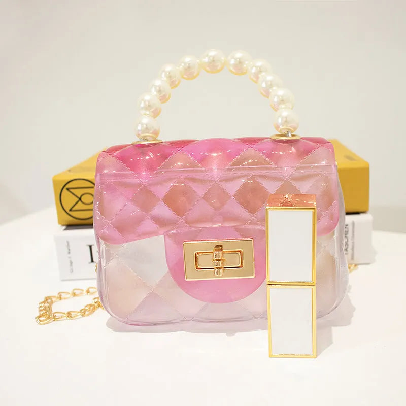 Mini kids crossbody bag in soft PVC with horizontal square shape, available in six colours including yellow, green, blue, black, and pink.
