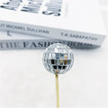 Glass mirrored disco ball cake decoration on a wooden stick, shown in different sizes.