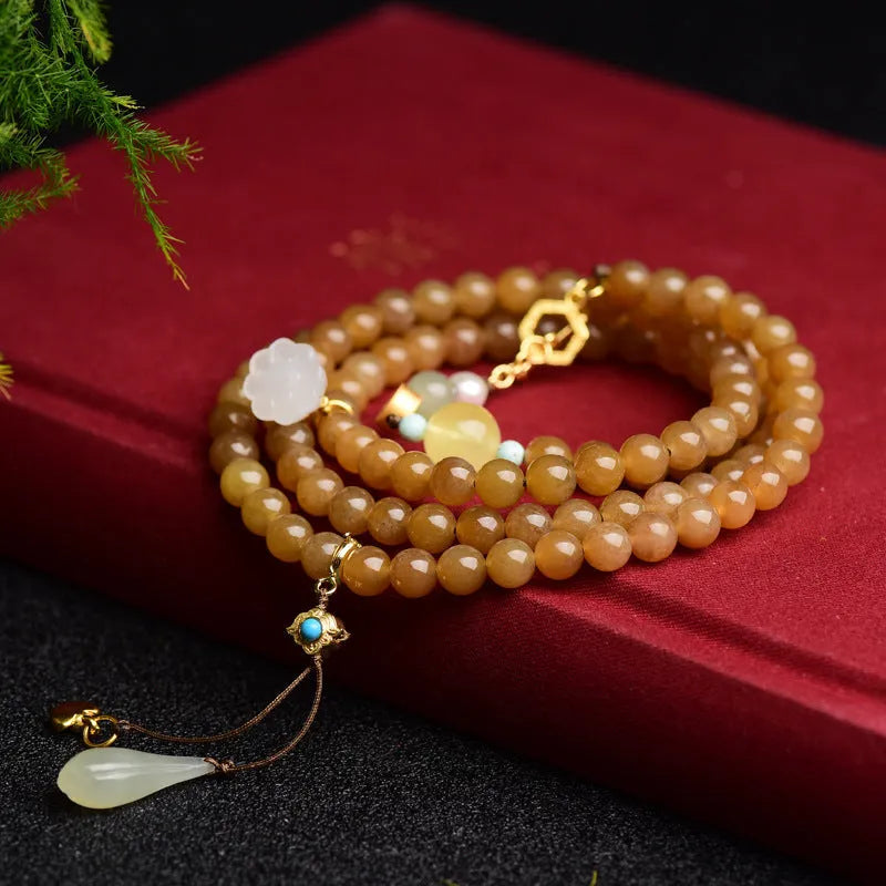 Women's water green pine jade bracelet with 6mm round beads and leaf-shaped sequin details.