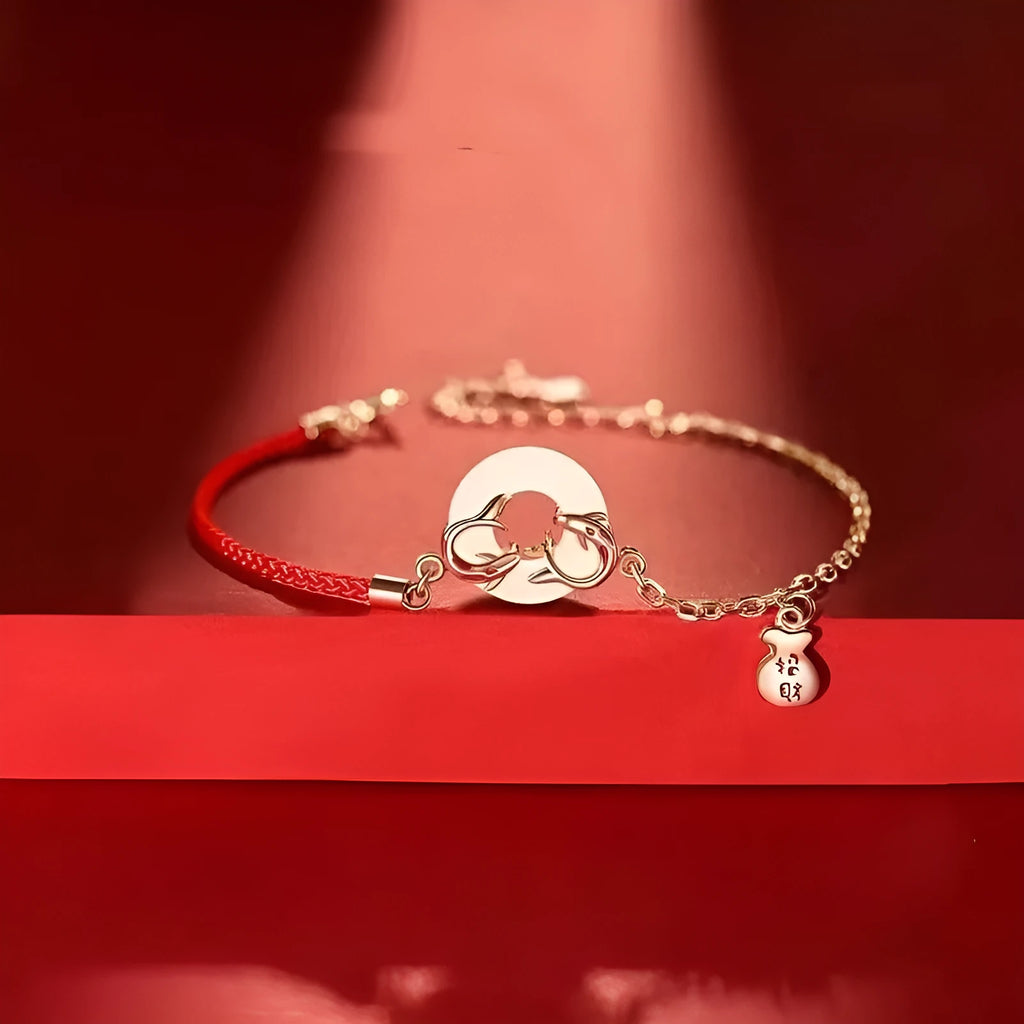 Red rope women's bracelet with peace buckle clasp and festive koi fishtail design