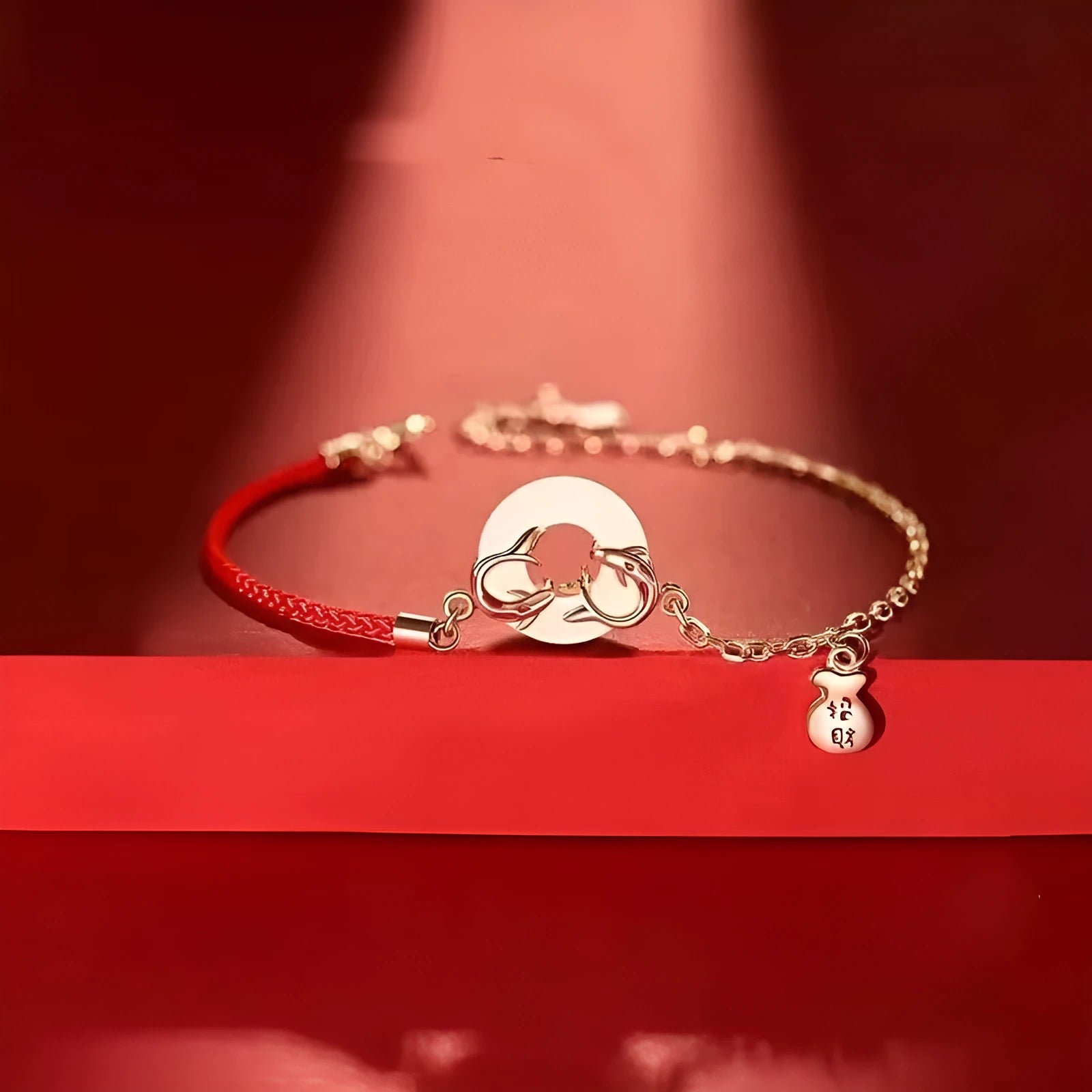 Red rope women's bracelet with peace buckle clasp and festive koi fishtail design