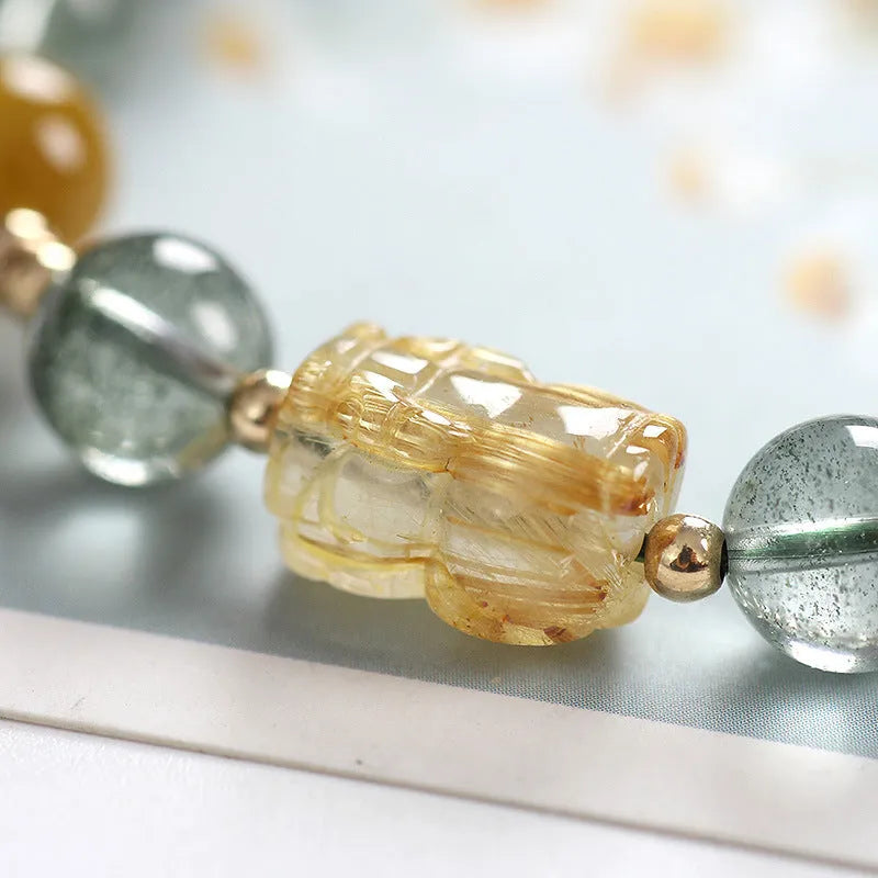 Green phantom quartz crystal bracelet with gold rutilated strands and 8mm geometric beads