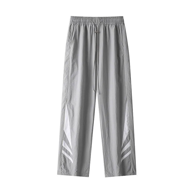 Men's black plus-size straight-leg casual trousers on a grey background, showing button detail and loose fit.
