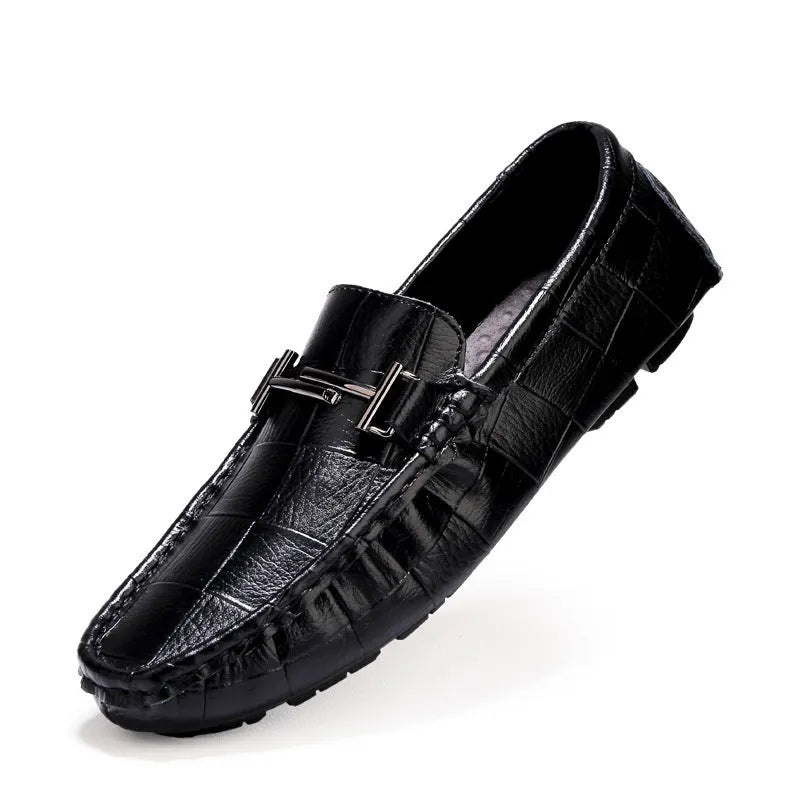 Men's black leather peas shoes with a silver belt buckle and flat rubber sole.
