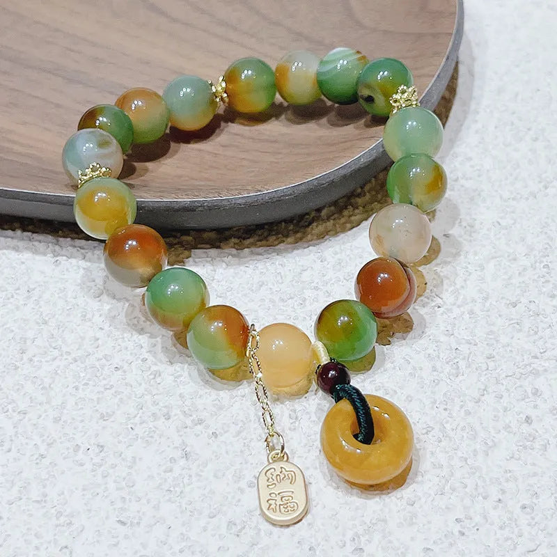 Yellow peacock agate women's bracelet with peace buckle closure measuring 1cm wide