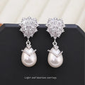 Women's drop-shaped pearl earrings with zircon stones and 18K gold finish