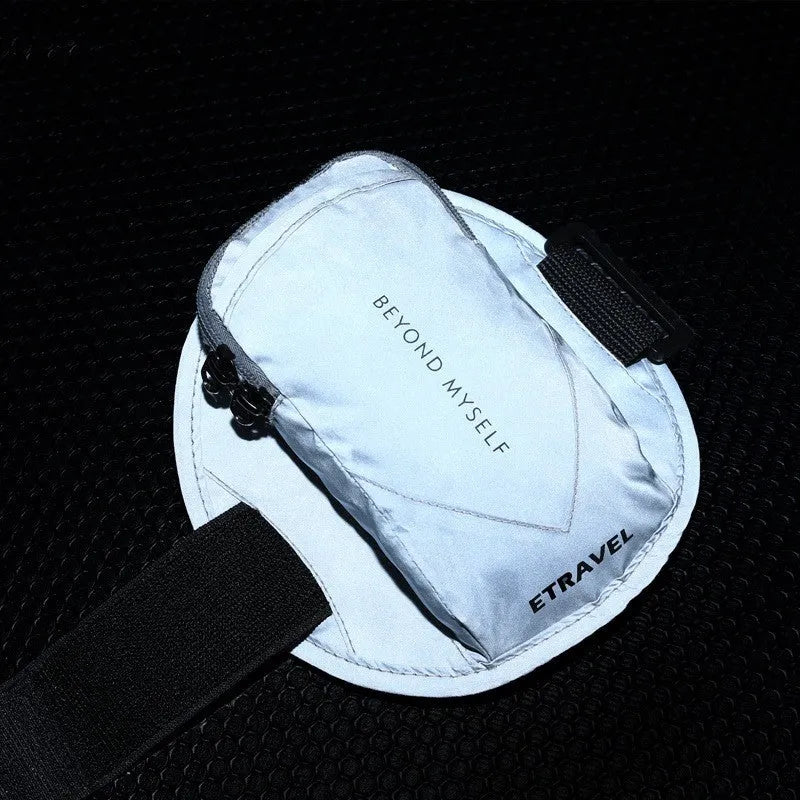 Black reflective running arm bag with adjustable strap, shown on an arm.
