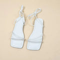 Women's flat sandals with ankle bandage cloth, square toe, and front lace-up in white, black, or orange.