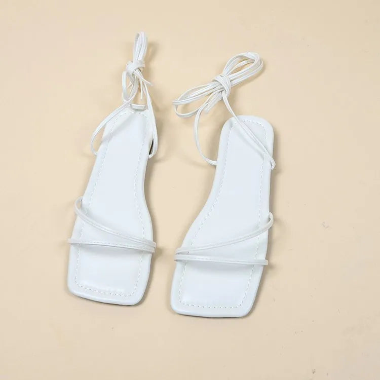 Women's flat sandals with ankle bandage cloth, square toe, and front lace-up in white, black, or orange.