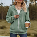 Green women's loose fit hooded zipper coat on a hanger