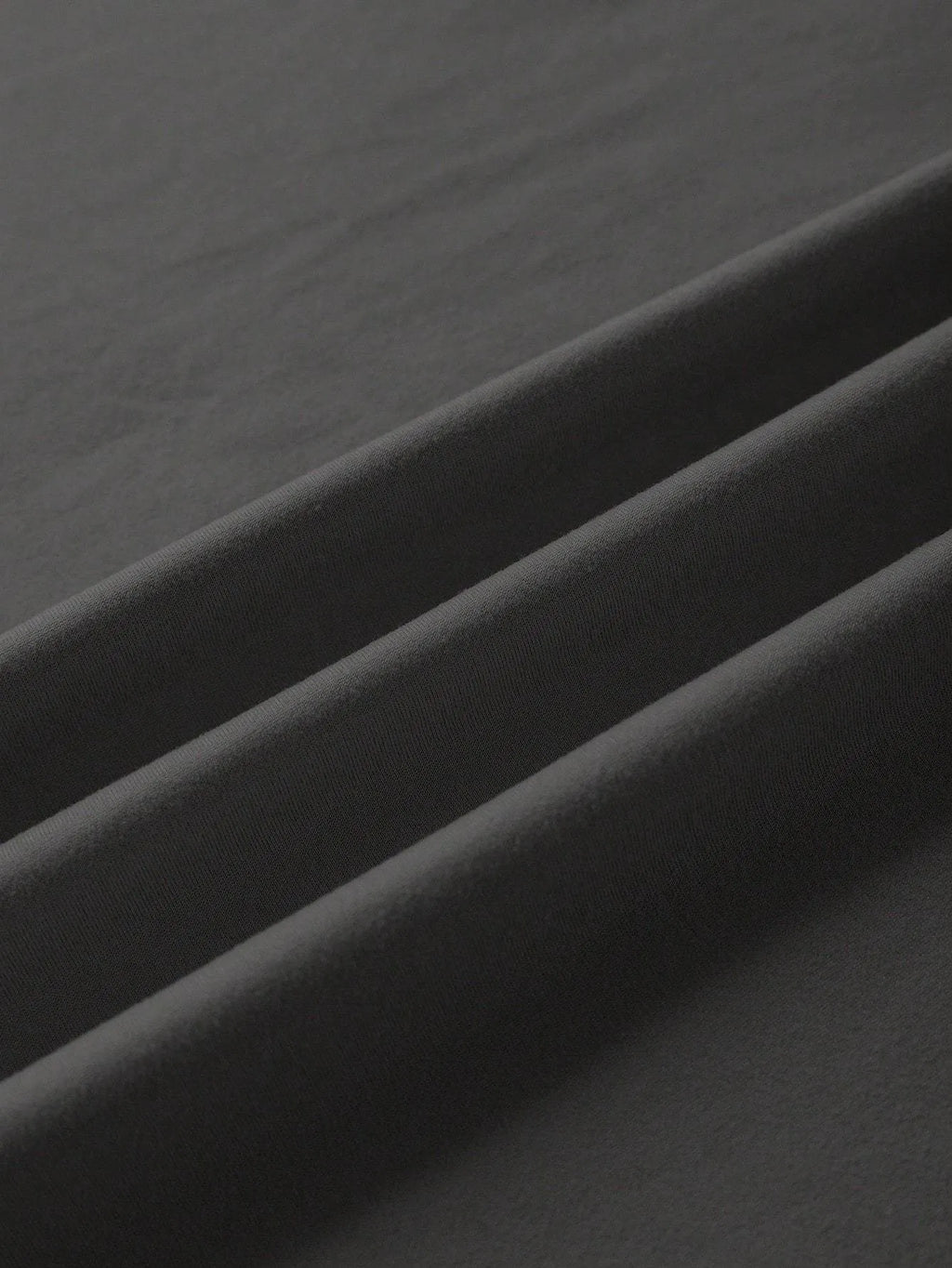 A loose-fitting unisex cotton T-shirt on a hanger, shown in one of its available colours.