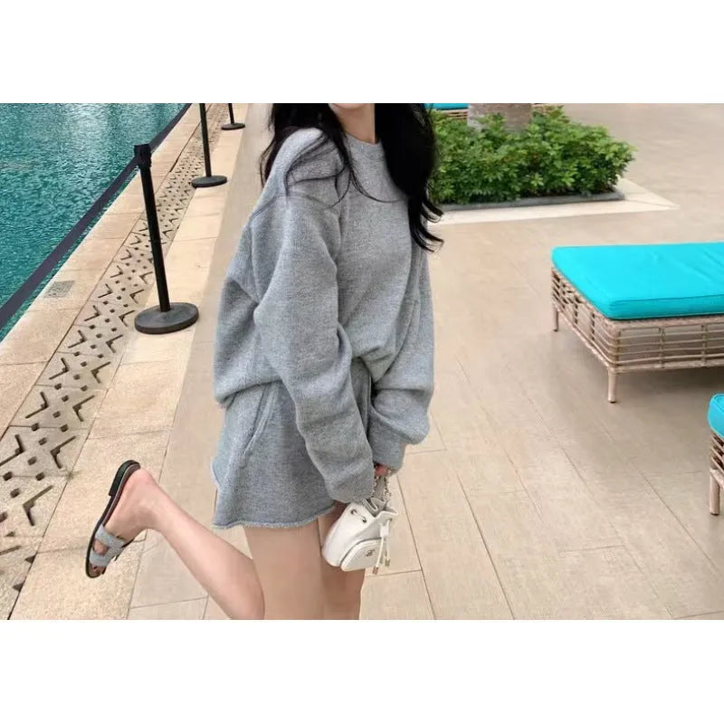 Women's loose-fitting long sleeve sweater and knitted wide leg shorts two-piece set in oatmeal colour.