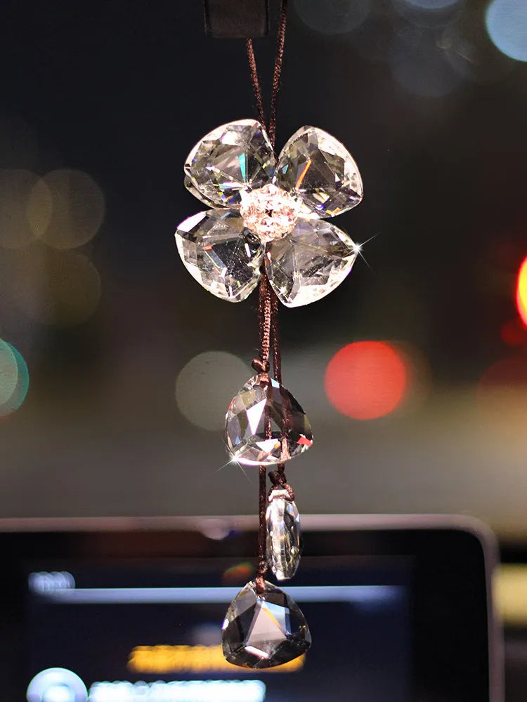 Crystal four leaf clover car pendant hanging, approximately 20 cm long, on a transparent background.