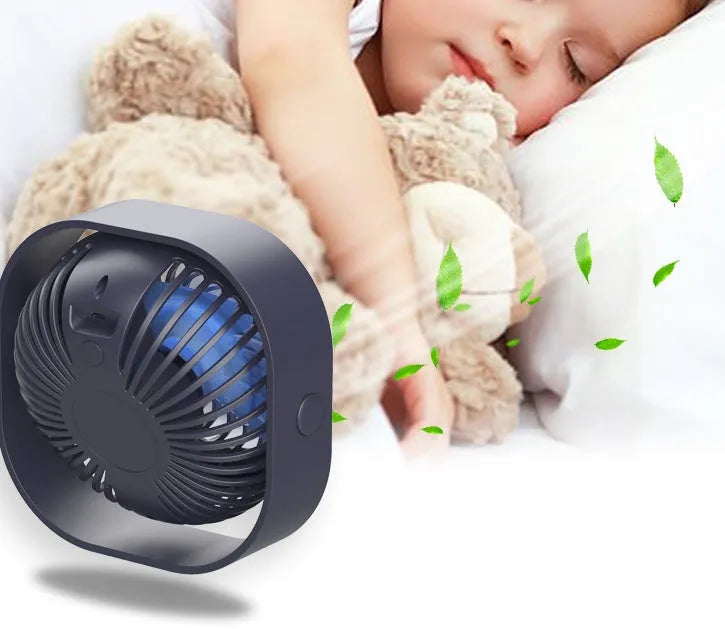USB-powered alarm clock fan in blue with 360-degree rotating head on a desk.